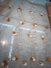 Embroidered lace on net 50&quot; wide     Beautiful champagne color embroided net fabric sold by the yard