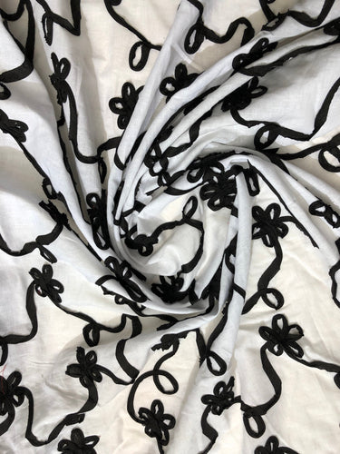 White Cotton with bjack cotton ribbon embroidery 54" wide    Fabric sold by the yard