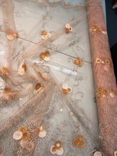 Embroidered lace on net 50&quot; wide     Beautiful champagne color embroided net fabric sold by the yard