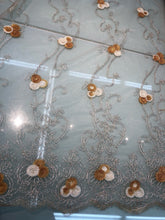 Embroidered lace on net 50&quot; wide     Beautiful champagne color embroided net fabric sold by the yard