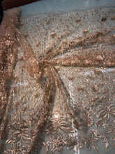 Floral abstract design sequins embroidered on mesh fabric sold by the yard