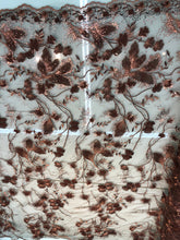 Floral thread embroidered with sequins embroidered on top of it on meah fabric sold by the yard