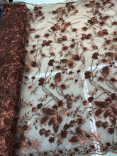 Floral thread embroidered with sequins embroidered on top of it on meah fabric sold by the yard