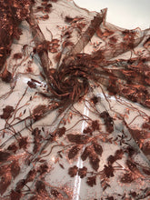 Floral thread embroidered with sequins embroidered on top of it on meah fabric sold by the yard