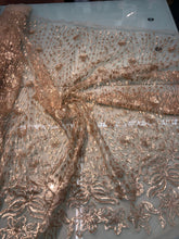 Floral abstract design sequins embroidered on mesh fabric sold by the yard