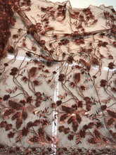 Floral thread embroidered with sequins embroidered on top of it on meah fabric sold by the yard