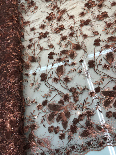 Floral thread embroidered with sequins embroidered on top of it on meah fabric sold by the yard