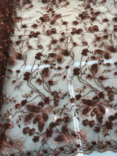 Floral thread embroidered with sequins embroidered on top of it on meah fabric sold by the yard