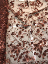 Floral thread embroidered with sequins embroidered on top of it on meah fabric sold by the yard