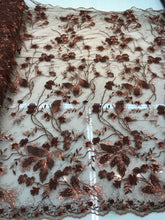 Floral thread embroidered with sequins embroidered on top of it on meah fabric sold by the yard