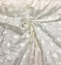 100% silk  58&quot; wide  Ivory silk with embosed ivory flowers on the fabric    Beautiful ivory color floral silk fabric sold by the yard