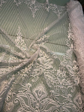 White bridal lace 52â wide.  Beautiful white bridal lace, border style white bridal lace fabric sold by the yard.