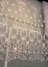 White bridal lace 52â wide.  Beautiful white bridal lace, border style white bridal lace fabric sold by the yard.