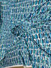 Designer digital print on Charmeuse fabric 54â wide.  Beautiful ivory base with blues combination sold by the yard.  Best use for Appearel