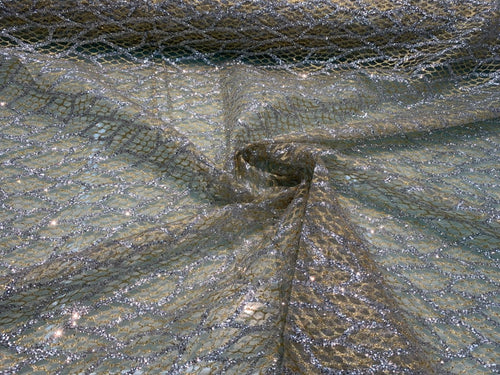 Glitter Metallic tule fabric useable for apparel, party decorations & much more..... 58â wide beautiful silver with gold on mesh