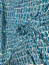 Designer digital print on Charmeuse fabric 54â wide.  Beautiful ivory base with blues combination sold by the yard.  Best use for Appearel