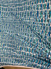 Designer digital print on Charmeuse fabric 54â wide.  Beautiful ivory base with blues combination sold by the yard.  Best use for Appearel