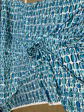 Designer digital print on Charmeuse fabric 54â wide.  Beautiful ivory base with blues combination sold by the yard.  Best use for Appearel