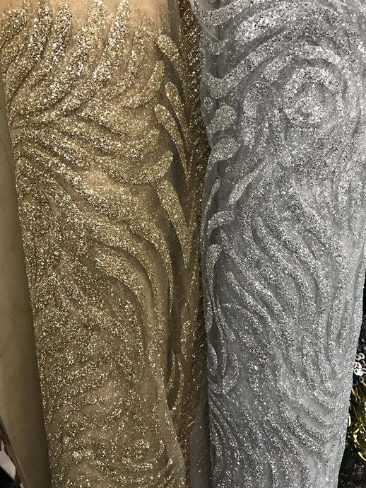 Glitter design on net fabric, this fabric is sold by the yard
